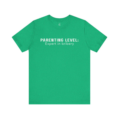 Parenting Humor Shirt | Unisex T-Shirt | Funny Parent Tee | Gift for Moms and Dads | Casual Family Outfit | “Parenting Level: Expert in Bribery”