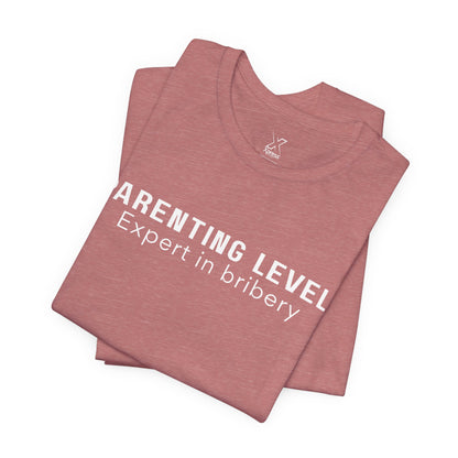 Parenting Humor Shirt | Unisex T-Shirt | Funny Parent Tee | Gift for Moms and Dads | Casual Family Outfit | “Parenting Level: Expert in Bribery”