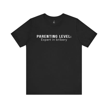 Parenting Humor Shirt | Unisex T-Shirt | Funny Parent Tee | Gift for Moms and Dads | Casual Family Outfit | “Parenting Level: Expert in Bribery”