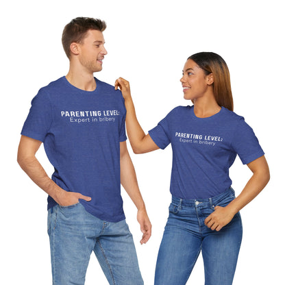 Parenting Humor Shirt | Unisex T-Shirt | Funny Parent Tee | Gift for Moms and Dads | Casual Family Outfit | “Parenting Level: Expert in Bribery”