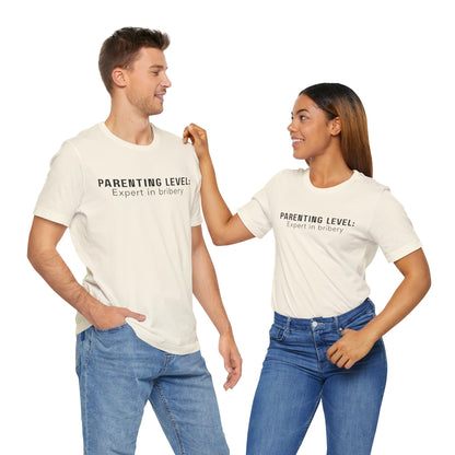 Parenting Humor Shirt | Unisex T-Shirt | Funny Parent Tee | Gift for Moms and Dads | Casual Family Outfit | “Parenting Level: Expert in Bribery”