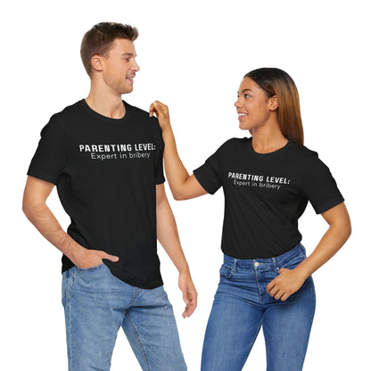 Parenting Humor Shirt | Unisex T-Shirt | Funny Parent Tee | Gift for Moms and Dads | Casual Family Outfit | “Parenting Level: Expert in Bribery”