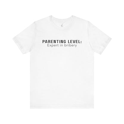 Parenting Humor Shirt | Unisex T-Shirt | Funny Parent Tee | Gift for Moms and Dads | Casual Family Outfit | “Parenting Level: Expert in Bribery”