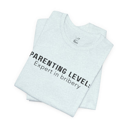 Parenting Humor Shirt | Unisex T-Shirt | Funny Parent Tee | Gift for Moms and Dads | Casual Family Outfit | “Parenting Level: Expert in Bribery”
