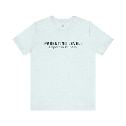 Parenting Humor Shirt | Unisex T-Shirt | Funny Parent Tee | Gift for Moms and Dads | Casual Family Outfit | “Parenting Level: Expert in Bribery”