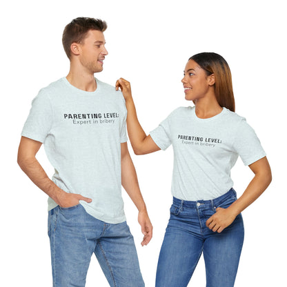 Parenting Humor Shirt | Unisex T-Shirt | Funny Parent Tee | Gift for Moms and Dads | Casual Family Outfit | “Parenting Level: Expert in Bribery”