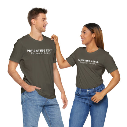 Parenting Humor Shirt | Unisex T-Shirt | Funny Parent Tee | Gift for Moms and Dads | Casual Family Outfit | “Parenting Level: Expert in Bribery”