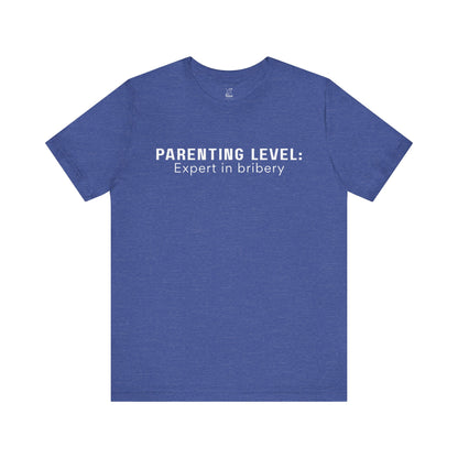 Parenting Humor Shirt | Unisex T-Shirt | Funny Parent Tee | Gift for Moms and Dads | Casual Family Outfit | “Parenting Level: Expert in Bribery”