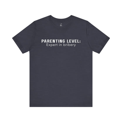 Parenting Humor Shirt | Unisex T-Shirt | Funny Parent Tee | Gift for Moms and Dads | Casual Family Outfit | “Parenting Level: Expert in Bribery”